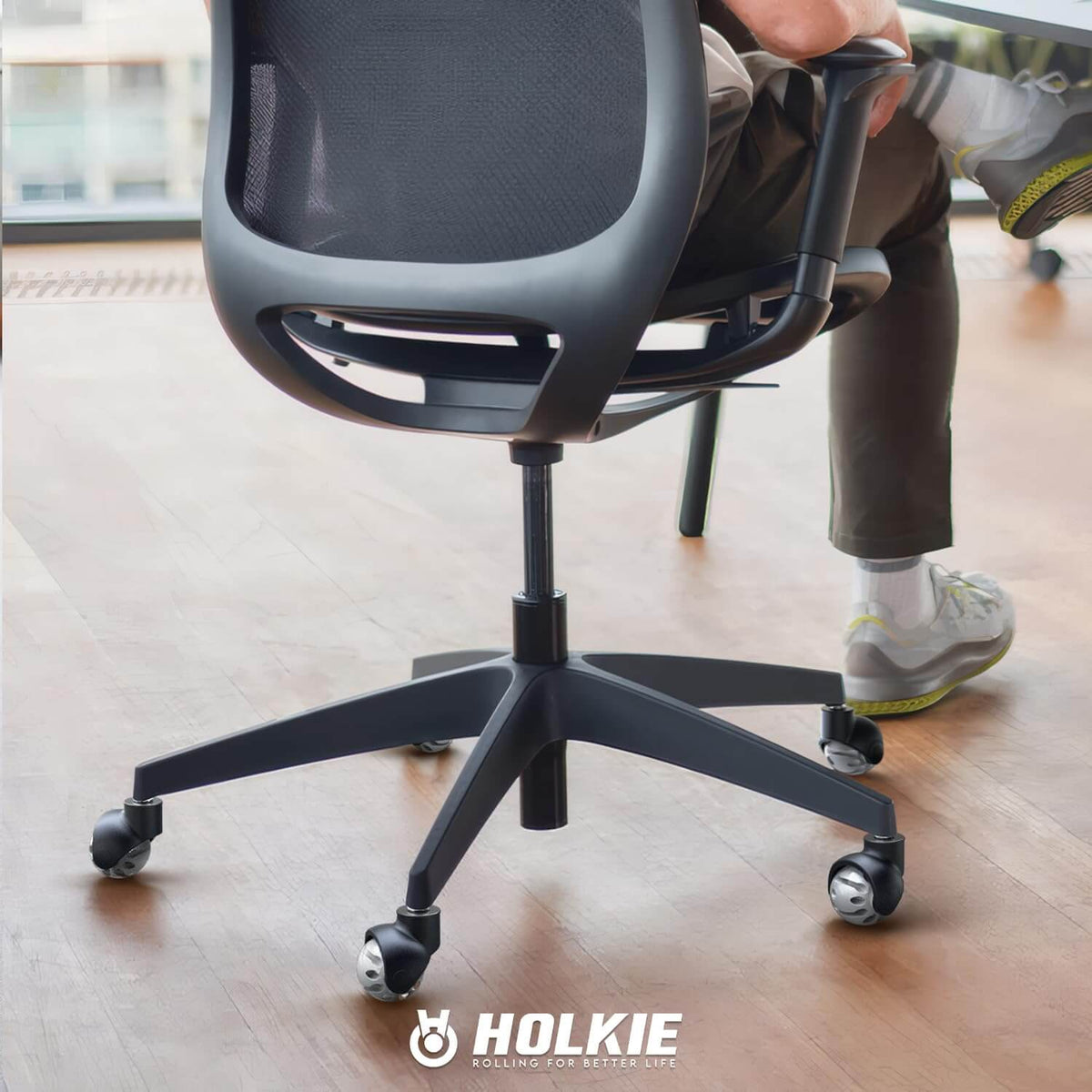 Office chair equipped with HOLKIE gray
rubber replacement caster wheels rolling on hardwood flooring