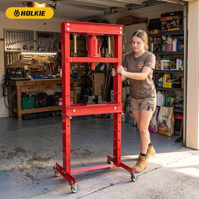 HOLKIE heavy-duty stem casters installed on a red hydraulic shop press in a garage workshop